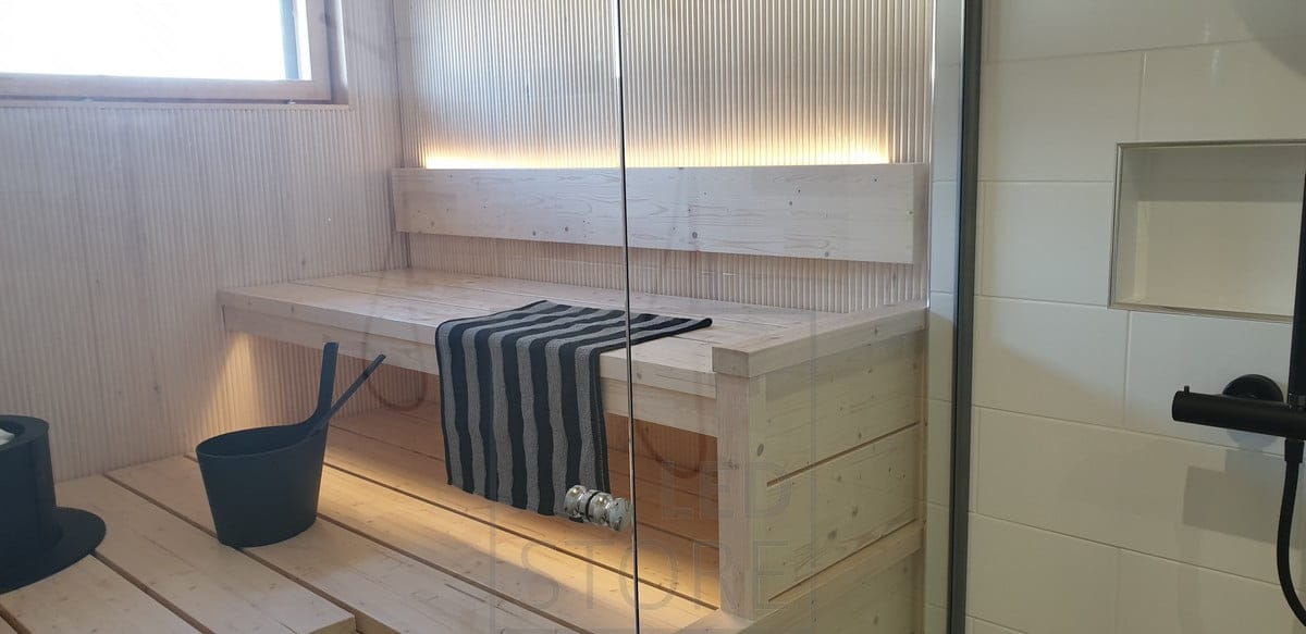 The backrest of the sauna has an LED strip to provide atmospheric light upwards and downwards under the ceiling. Ledstore.fi